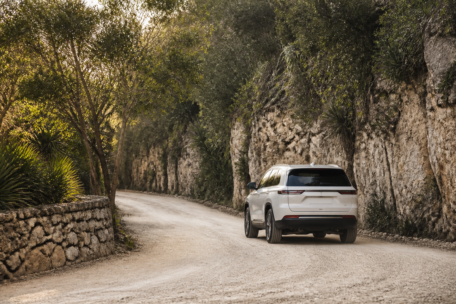 White private transfer vehicle traveling on a limestone road near Tulum